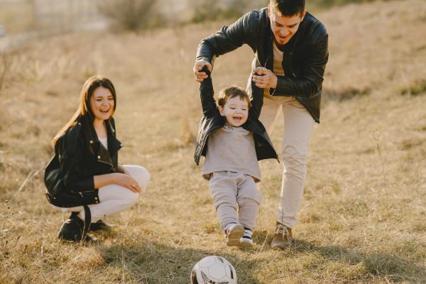 play therapy. child counseling and parent counseling in frisco, tx. Mom, dad, and child playing together.